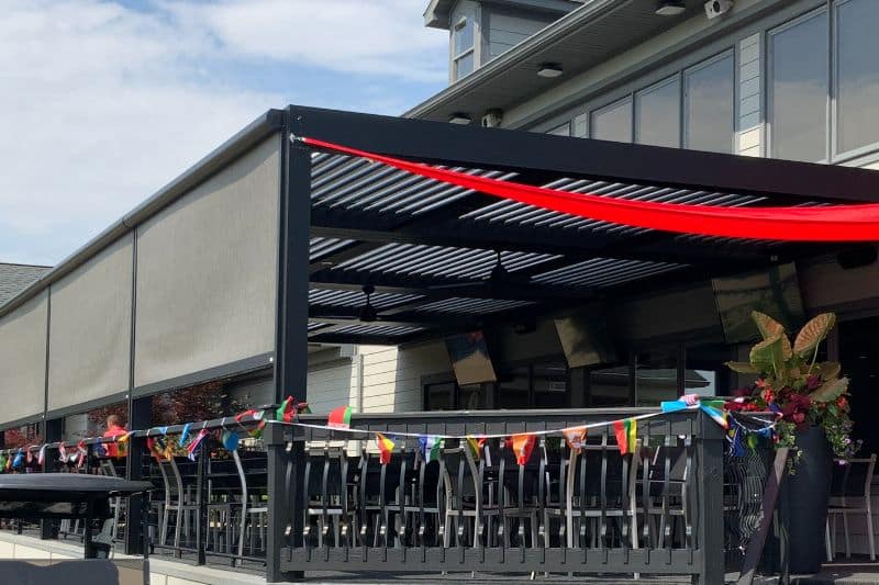 commercial pergola with a screen for the dining area