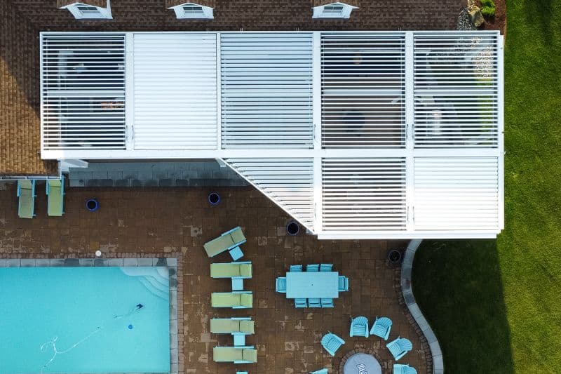 arial view showcasing a poolside pergola to show pergolas that open and close