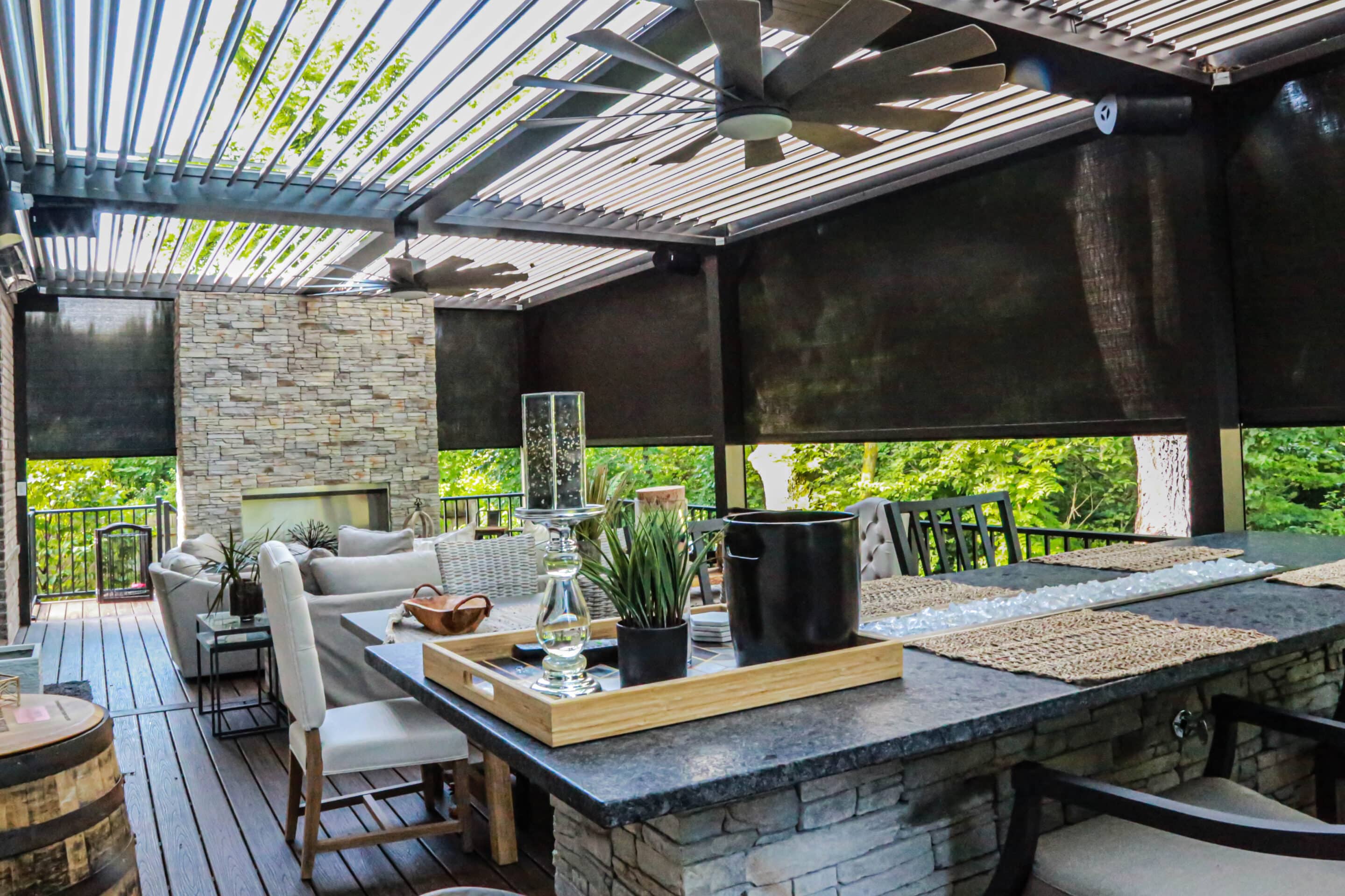 Outdoor living space with an motorized louvered pergola from The Smart Pergola® enhanced with a retractable pergola screen to enhance comfort and privacy.